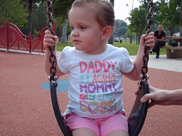 A blind child playing on a swing at park day